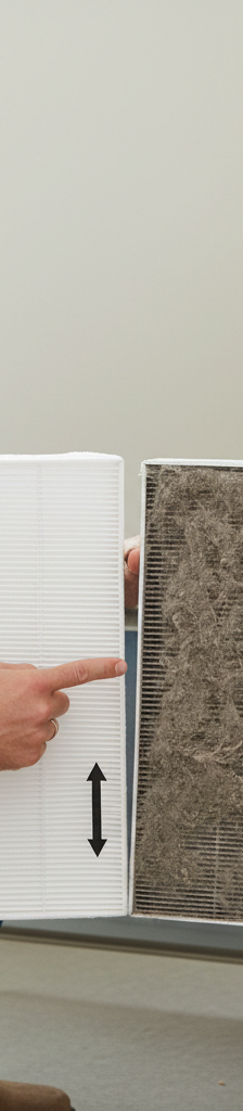 Homeowner checking dirty AC air filter in furnace