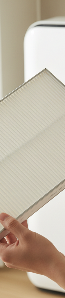 Homeowner checking a clean air filter in an indoor AC unit
