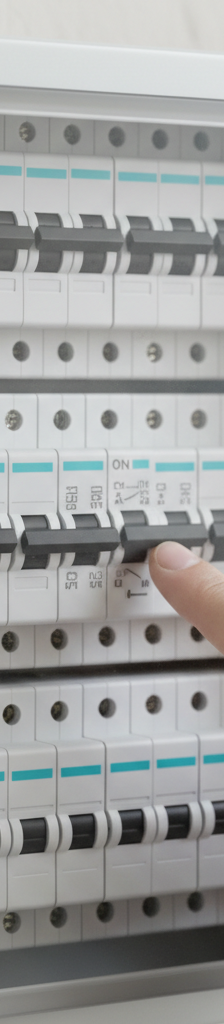 Homeowner identifying a tripped circuit breaker in a modern electrical panel.