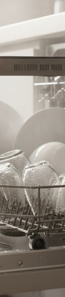 Close-up of wet dishes in a dishwasher, with a hand pointing to the dishwasher's vent, indicating a common problem for poor drying.