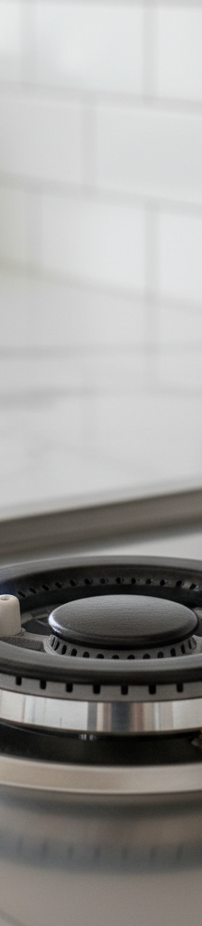 Close-up of gas stove burner with igniter sparking