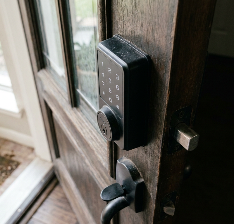 A matte black electronic keypad deadbolt on a front door that is not working.