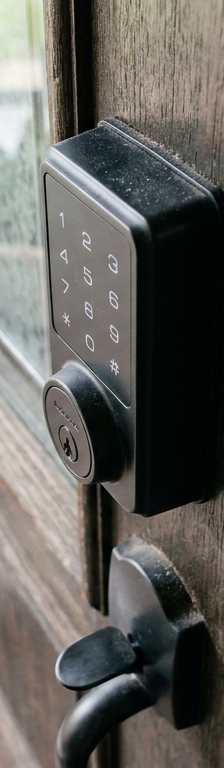 A matte black electronic keypad deadbolt on a front door that is not working.