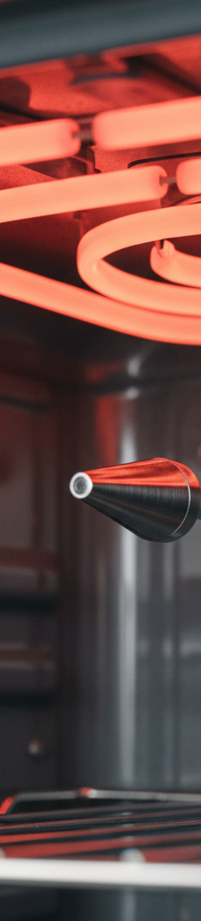Inside an oven, showing a glowing red heating element and a temperature sensor probe.