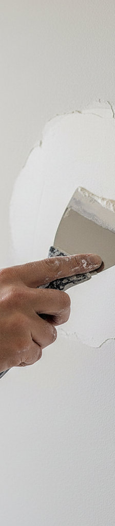 Homeowner applying joint compound to a small drywall patch, demonstrating feathering technique for an invisible repair.