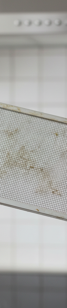 Homeowner checking circuit breaker for a non-working range hood fan