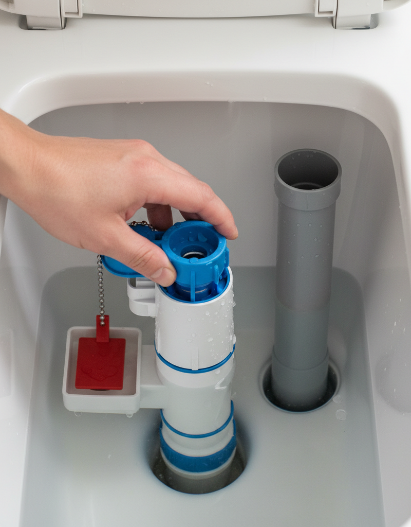 Hand shown adjusting the float cup mechanism inside a toilet tank to stop a running toilet.
